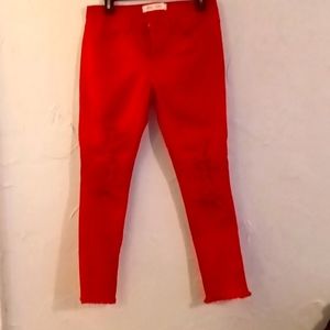 Bright red ripped jeans